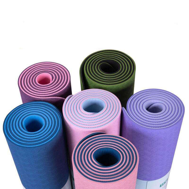 Colorful rolled yoga mats for home gym workouts and fitness routines