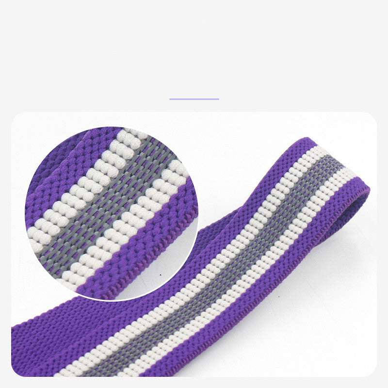 Purple resistance band with gray and white stripes, ideal for home gym workouts and strength training.